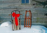 This charity holiday card fetures two old fashioned sleds again an aging barn.  This card supports Feeding America.